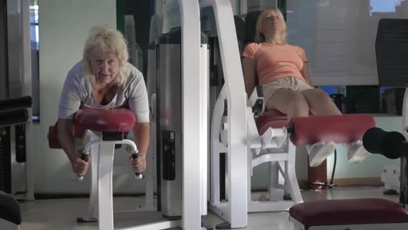 Women Doing Leg Exercises on Fitness Machines