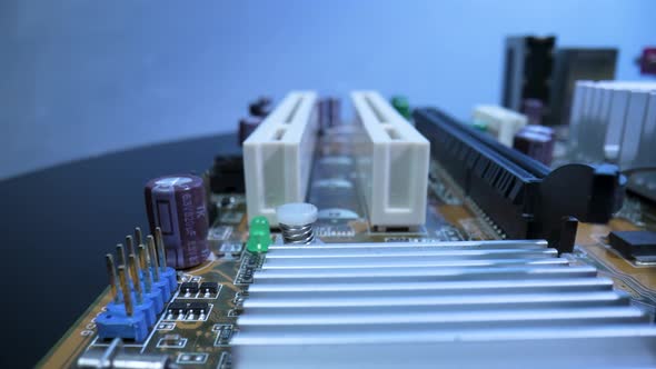 Computer Motherboard Microcircuit with Heatsink for Cooling Capacitors and Slots for RAM