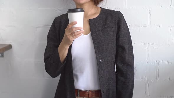 Young Attractive Businesswoman Drinking Coffee, Slow Motion.