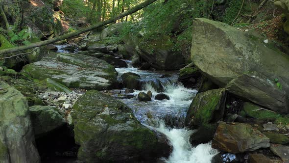 Mountain river flowing over rocks and boulders in forest, Bistriski Vintgar, Slovenia, hiking and ou