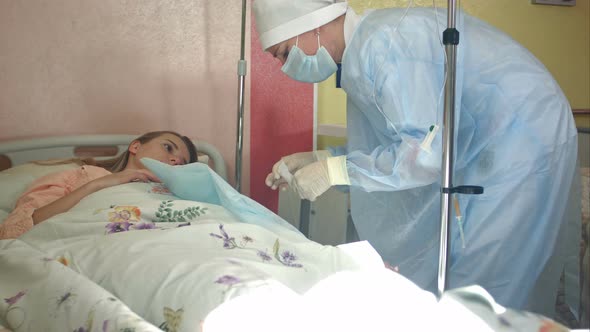 Nurse Preparing Female Patient Arm To Put IV Tube