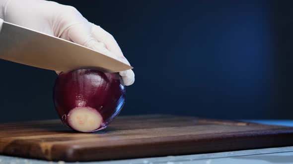 Experienced Vegan Cuts Purple Onion with Large Steel Knife