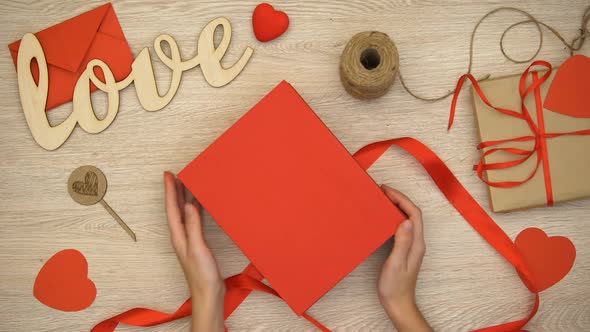 Hands Packing Valentines Gift Box With Heart-Shaped Chocolate Candies, Romantic