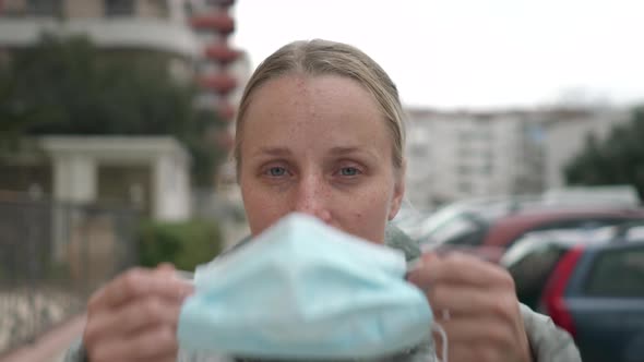 Woman Putting on Surgical Mask for Corona Virus Prevention.