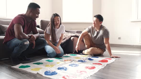 Diverse Group of Friends Plating Twister at Home