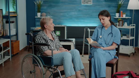 Nurse Giving Assistance to Retired Woman in Nursing Home