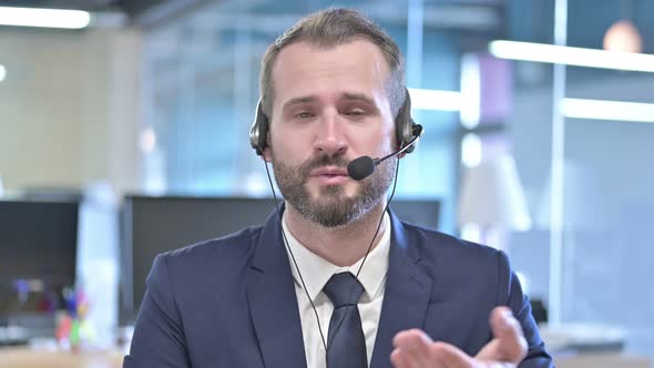 Portrait of Young Businessman Talking on Headset