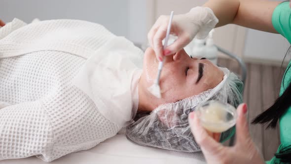 Woman Beautician Makes Procedures Facial Cleans Patient