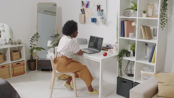 African American Businesswoman Video Chatting on Laptop from Home