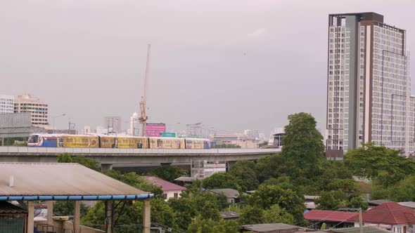 Sky Train Travels From Rural Area Into The City