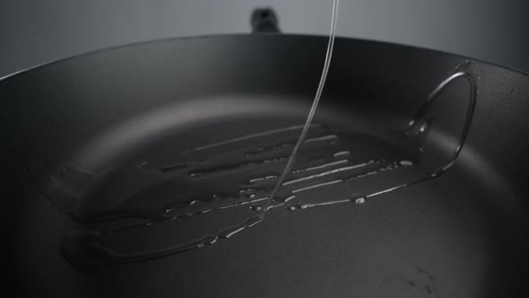 Sunflower Oil Is Being Poured To the Hot Pan in Slow Motion, Greasing the Pan, Preaprations