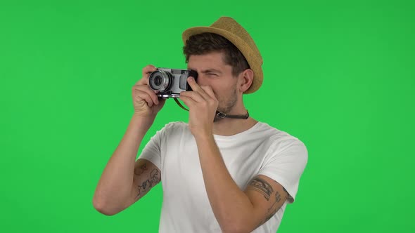 Portrait of Tourist in Hat on Vacation Takes Pictures on a Retro Camera