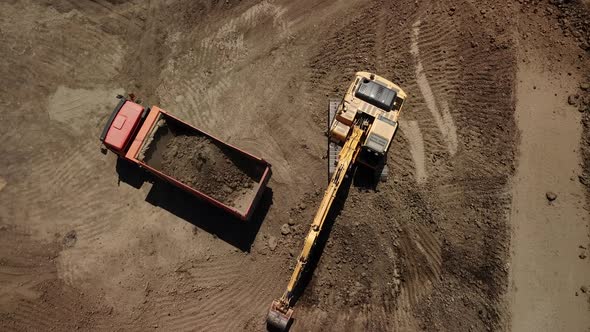 Excavator Pours Sand Into the Truck