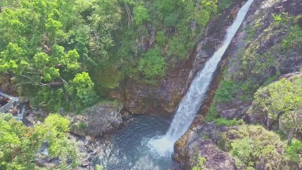 Waterfall TaGu Streams Powerfully Into Creek Among Jungle