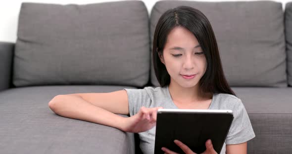 Woman look at tablet computer at home