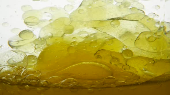 Close-up View of a Mix of Peanut and Vegetable Oil for Food in a Container. Olive Oil Is Mixed with