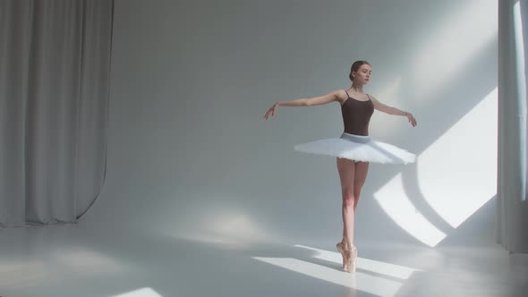 Female Dancer Does Ballet Exercises in Stage Dress with Open Back, Rehearses Dance Moves 