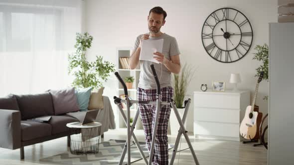 Wide video of man  exercising and working at home