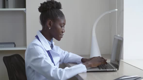 Professional Doctor Using Computer in Office