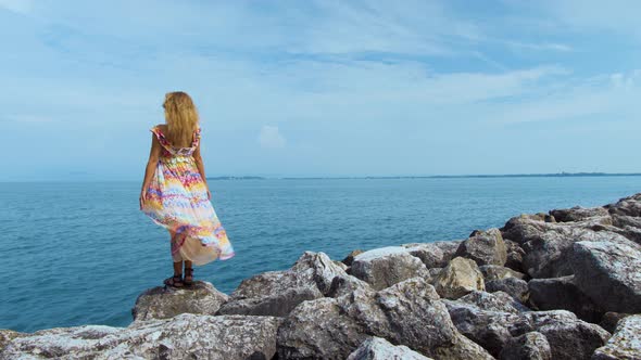 Girl in a Beautiful Dress Is Standing on the Coast