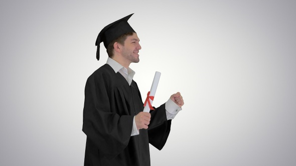 Man walking to the graduation ceremony on gradient background.