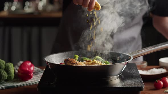 Chef Frying Chicken Breast in Pan Mexican Spicy Cuisine Indian Food Arabian Spices and Hot Pepper