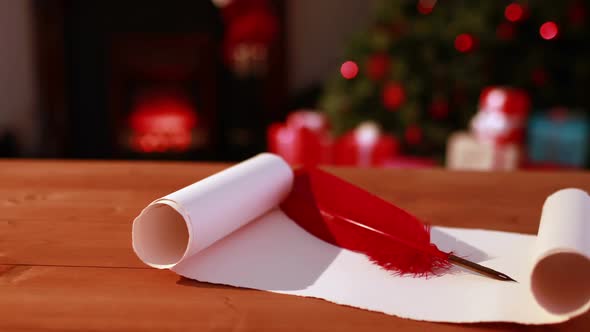 Scroll and quill on table at christmas