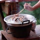 People cooking and eating Moo Kata, Thai barbecue grill pork on circle hot pan - VideoHive Item for Sale