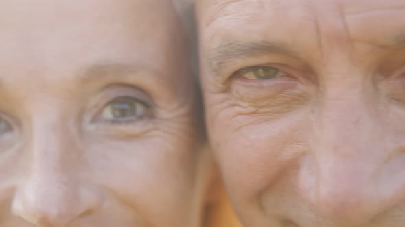 Macro Shot of Eyes of Beautiful Mature Couple Looking at Camera