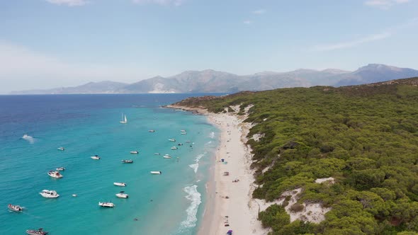 Aerial View of Ocean with Boatswaves Crashing Against Beach