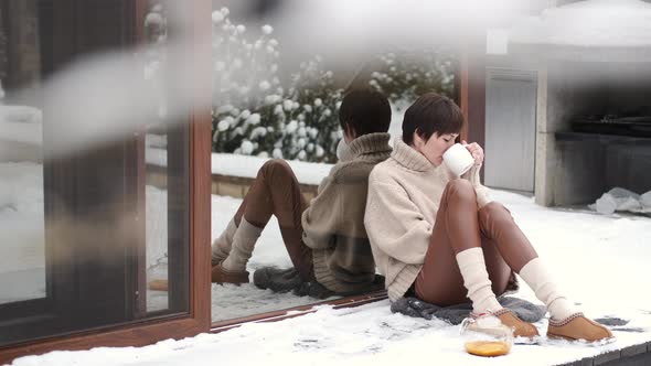 Peaceful Young Woman Drink Tea on Home Terrace in Winter