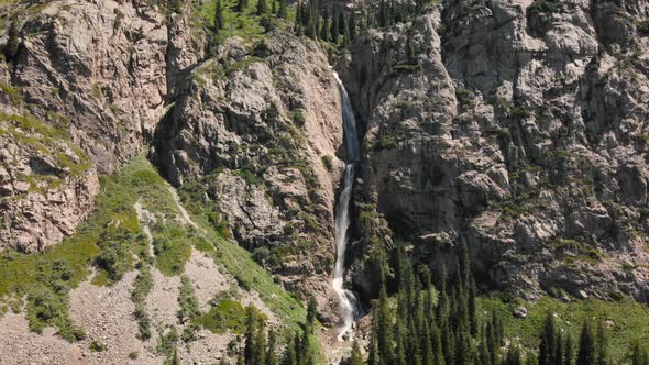 Burkhan Bulak Waterfall in the Mountains in Central Asia