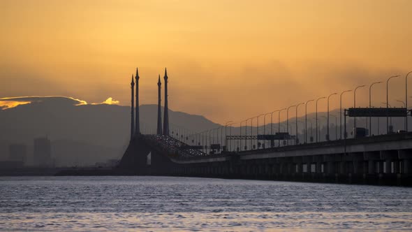 Timelapse orange sun rise up over Penang Bridge