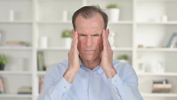 Portrait of Tired Middle Aged Businessman Having Headache