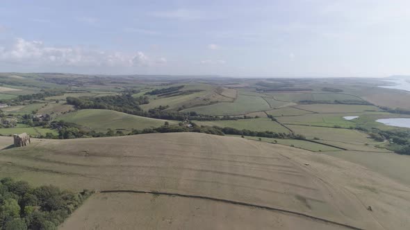 Aerial tracking forward high above the fields of Dorset. The Chapel of St Catherine sits on top of t
