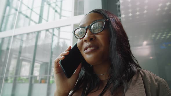 Black Businesswoman Talking on Phone in Elevator