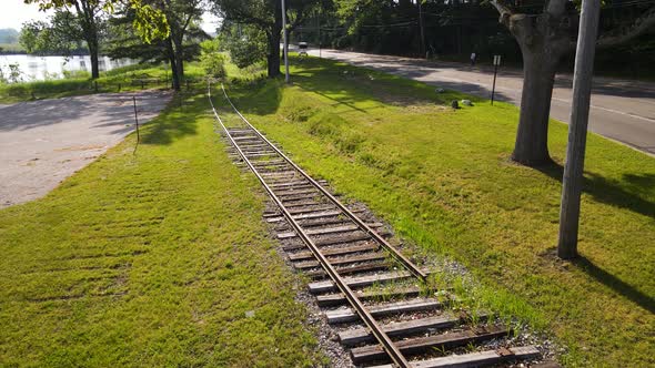 Summer weather sun beaming on old train tracks in the morning.