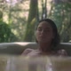 A girl in a bathtub in a forest during the rain. Beautiful young woman relaxing in the bathroom - VideoHive Item for Sale