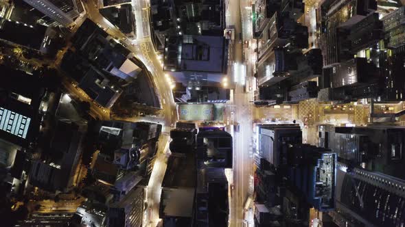 Aerial top down view of a football field in Hong Kong downtown at night.