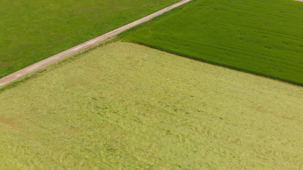 flying over rolling hills with fields in a rural countryside