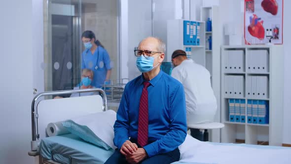 Old Man Wearing Mask at Doctor Appointment