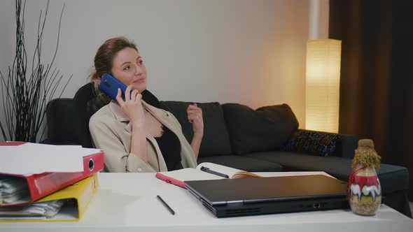 Business woman portrait talking enthusiastically on the phone