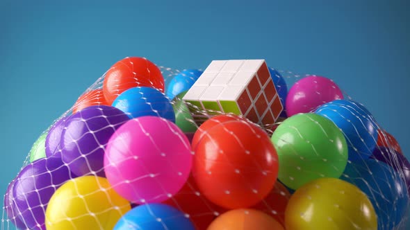 Rubik's cube on colorful plastic ball rotate