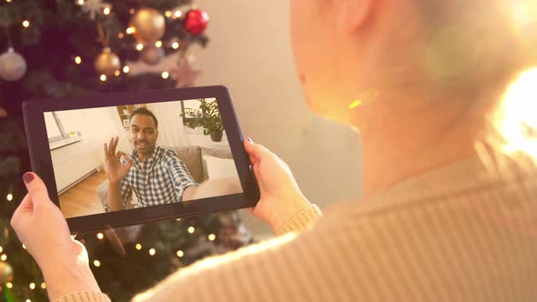 Woman with Tablet Pc Has Video Call on Christmas