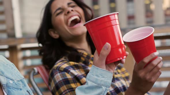 Young adult friends hanging out on a rooftop