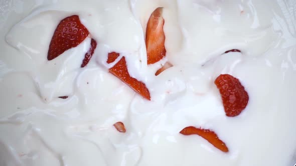 Strawberry Falling in White Yogurt Cream