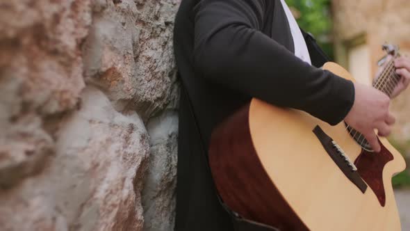 Unrecognizable Street Musician Playing Outside