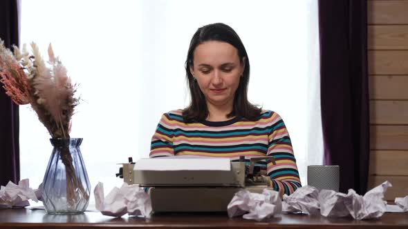Woman Using Vintage Manual Typewriter at Home
