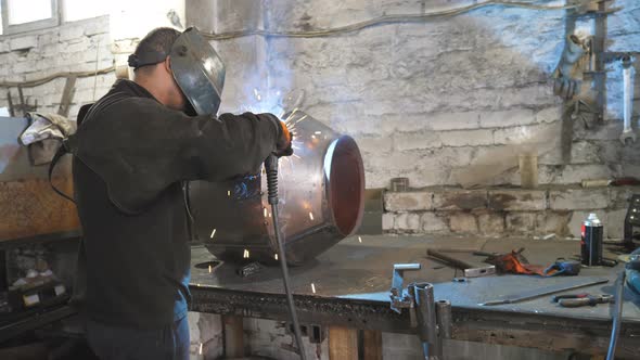 Welder Welding Metal Construction at Industrial Metalworking Production