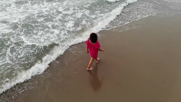 Woman in a Dress Walking Into the Water By Sand Beach on the Seaside on Sunset, Inspirational